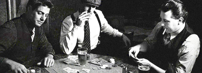 Mobsters playing cards at an illegal establishment in the 1920's.